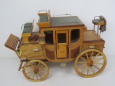A delightful wooden scale model of a stagecoach 