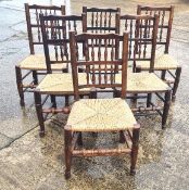 A set of six cane seated dining chairs having spindle bobbin turned backs.