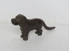 A cast iron nut cracker in the form of a dog.
