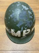 A WWII US M1 MP helmet. Paint is flaky (please see photos). This lot will be available to collect in