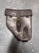 A Vickers WWII front sight in case together with a leather Vickers Clinometer case dated 1943.