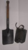 A WWI central powers entrenching tool and leather sheath - lion symbol to head.