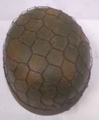 A reproduction WWII German Paratrooper helmet with netting.