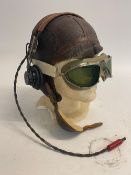 A WWII Pilots B5 helmet with goggles and headphones, headphones marked anb-h-1.
