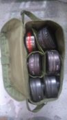 Twelve British gas mask filters in original transit bag.