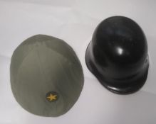 A North Vietnamese Army helmet, together with a Cold War German Firefighter helmet. Two items.