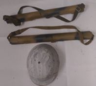A WWII German winter camo helmet, together with two MG42 barrel cases.
