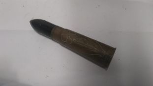 A WWI British 13pdr shell with flower themed trench art upon.