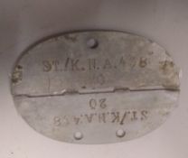 A WWII German dog tag. This lot will