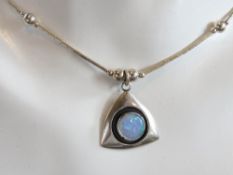 An opal and silver bead necklace in the Native American Navajo style.