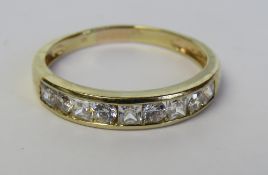 A 14ct gold half eternity ring set with nine cz stones being alternate princess and round cut in