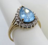 A 9ct gold cocktail ring having large teardrop shaped blue stone in claw setting, hallmarked 375,