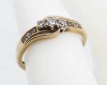 A 9ct gold ring having three central graduated round cut spinel in claw settings,
