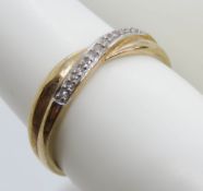 A 9ct gold and diamond crossover style ring, stamped 9ct, size J-K, 1g.