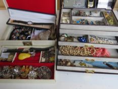 A quantity of assorted costume jewellery within two leatherette jewellery boxes.