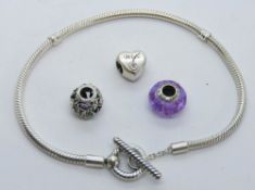 A silver Pandora charm bracelet together with three bead charms each stamped S925 ALE.