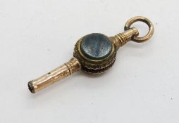 A delightful pocket watch winder key having bloodstone and carnelian panels.