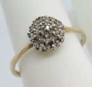 A 9ct gold diamond cluster ring, four layer in white metal totaling 0.