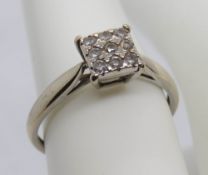 A 9ct white gold and diamond ring, the nine round cut stones set in a square head totalling 0.