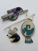 A Mexican sterling silver brooch set with crushed turquoise,