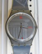 A Swatch watch in Obelisque pattern, original packaging, new battery within box.