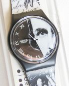 A Swatch watch in Glance pattern, original packaging, new battery within box.