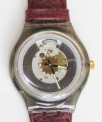 An automatic Swatch watch in Rubin pattern, within original packaging.