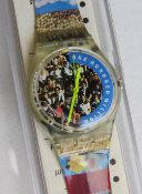 A Swatch watch in The People pattern, incorrect packaging, new battery within box.