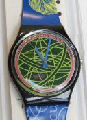 A Swatch watch in The Globe pattern, original packaging, new battery within box.