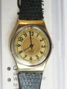 A Swatch watch in Noblesse Oblige pattern, original packaging, new battery within box.