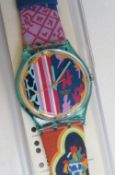 A Swatch watch in Mogador pattern, original packaging, new battery within box.