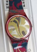 A Swatch watch in Louis Louis pattern, original packaging, new battery within box.