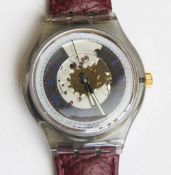 An automatic Swatch watch in Rubin pattern, within original packaging.