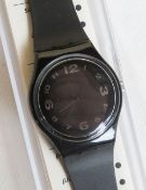A Swatch watch in After Dark pattern, original packaging, new battery within box.