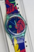 A Swatch watch in Ibiskus pattern, original packaging, new battery within box.