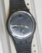 A Swatch watch in High Beam pattern, original packaging, new battery within box.