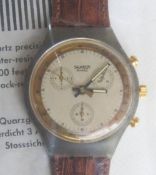 A Chrono Swatch watch in Goldfinger pattern, part packaging, new battery within bag.