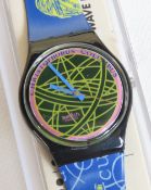 A Swatch watch in The Globe pattern, original packaging, new battery within box.