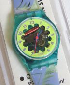 A Swatch watch in Dahlia pattern, original packaging, new battery within box.