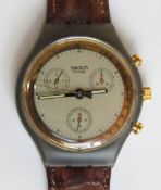 A Chrono Swatch watch in Goldfinger pattern, original packaging, new battery within bag.