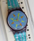 A Swatch watch in Compass pattern, original packaging, new battery within box.