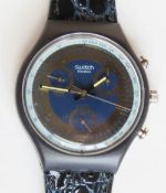 A Chrono Swatch watch in Goldfinger pattern, original packaging, new battery within bag.