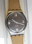 A Swatch watch in Country pattern, original packaging, new battery within box.