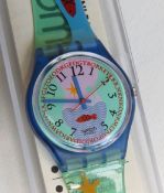 A Swatch watch in Hookipa pattern, incorrect packaging, new battery within box.