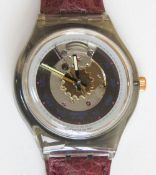 An automatic Swatch watch in Rubin pattern, within original packaging.