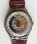 An automatic Swatch watch in Rubin pattern, within original packaging.