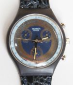 A Chrono Swatch watch in Goldfinger pattern, original packaging, new battery within bag.