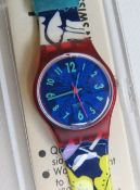 A Swatch watch in Exotica pattern, original packaging, new battery within box.