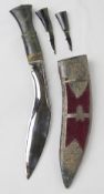 A presentation Kukri having Gurkha emblem to the white metal and burgundy velvet sheath.