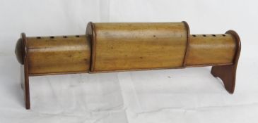 An Edwardian purpose made mahogany spurs rack in the form of a stable saddle rack.